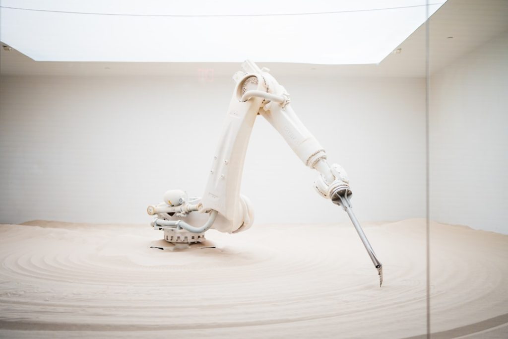 Humanoid robot and industrial robot arm comparison in a manufacturing environment