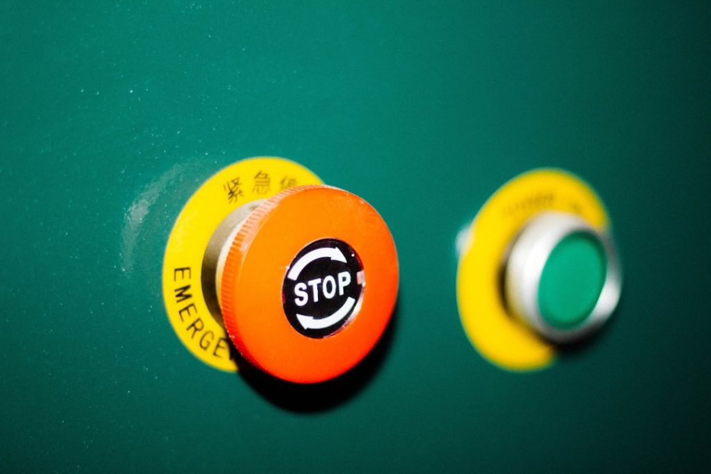 Industrial robot safety fencing and emergency stop system in a manufacturing cell