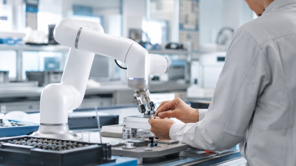Collaborative robot arm working next to a human operator at an assembly bench without a safety fence