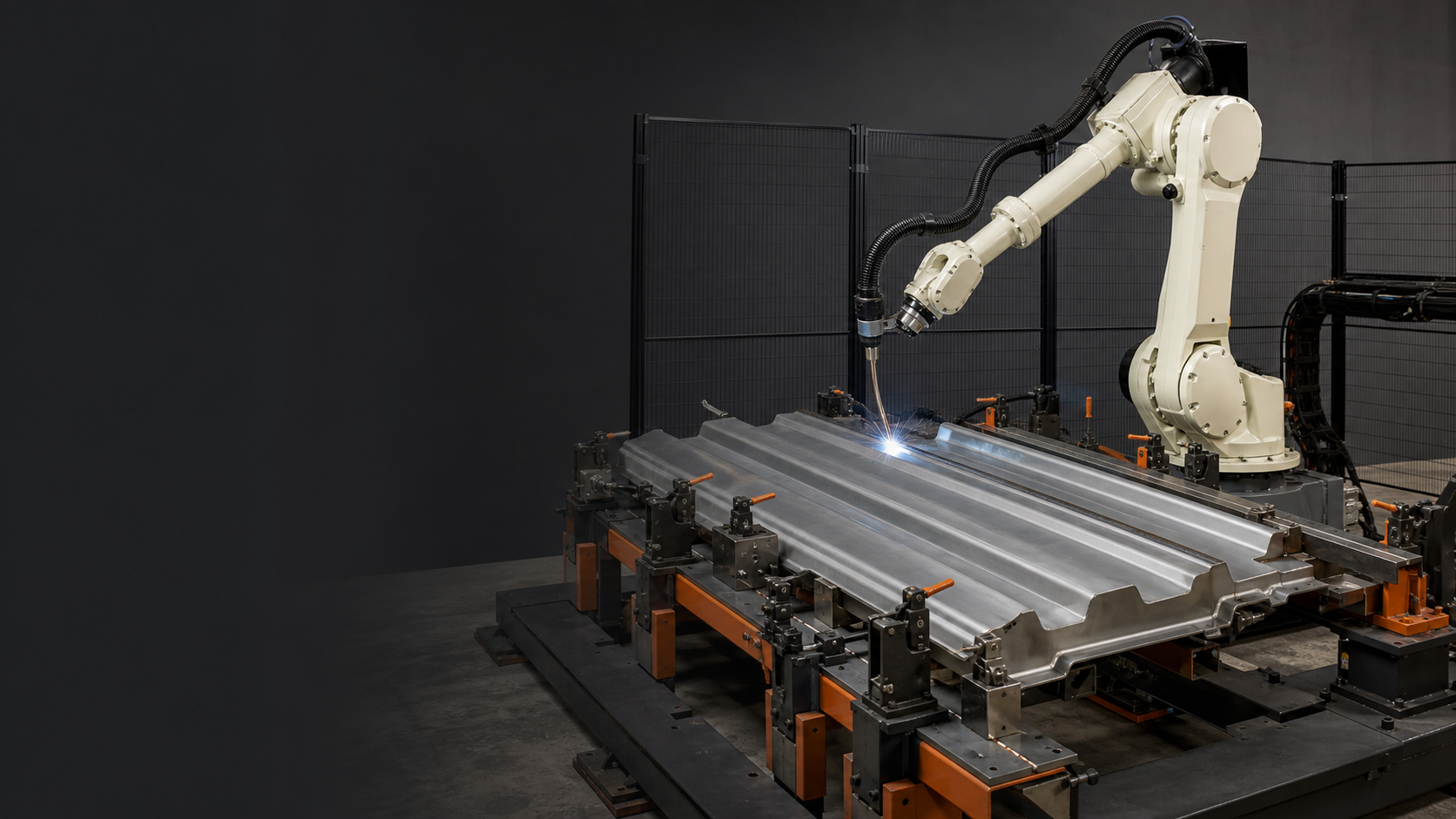 Robotic welding torch following a joint on a corrugated steel plate held in a clamped fixture