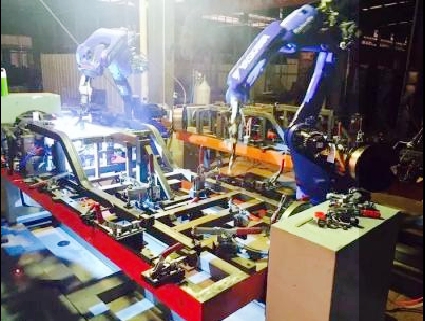 Robots working around a vehicle-frame fixture
