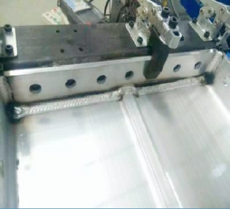 Weld bead and fixture detail on a positioned workpiece