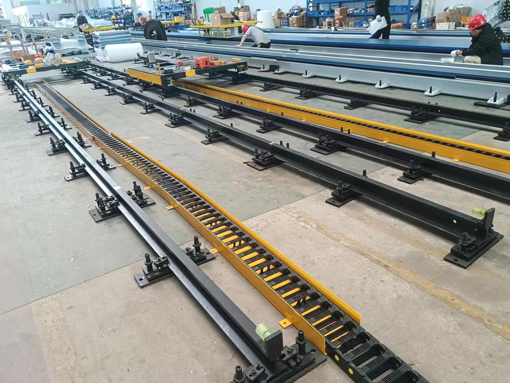 Ground-mounted robot tracks being assembled in the workshop
