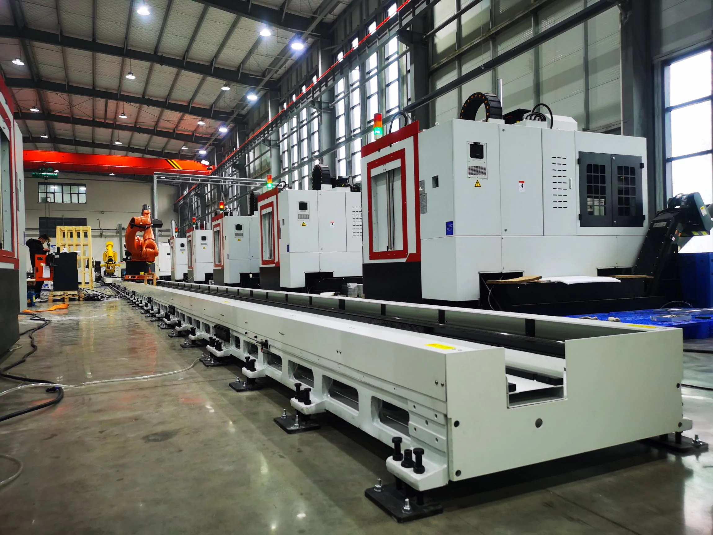 Ground robot track serving a row of machine tools
