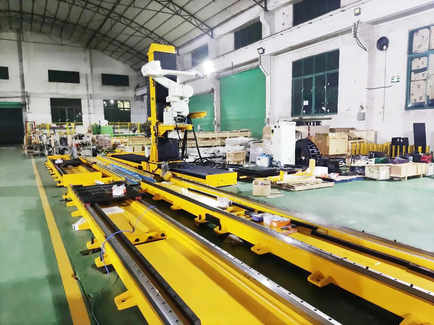 Yellow robot track installed beside a spray-line work area