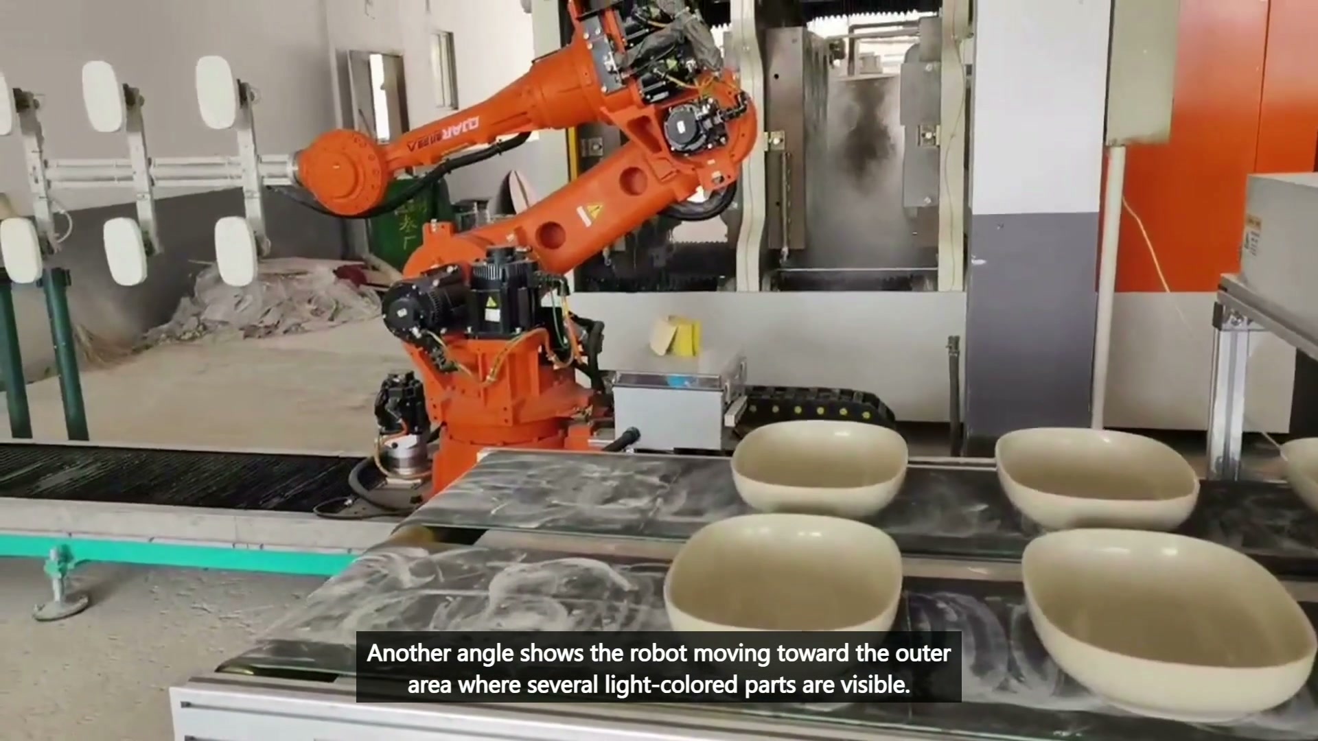 Robot beside equipment and bowl-shaped parts on the outer table