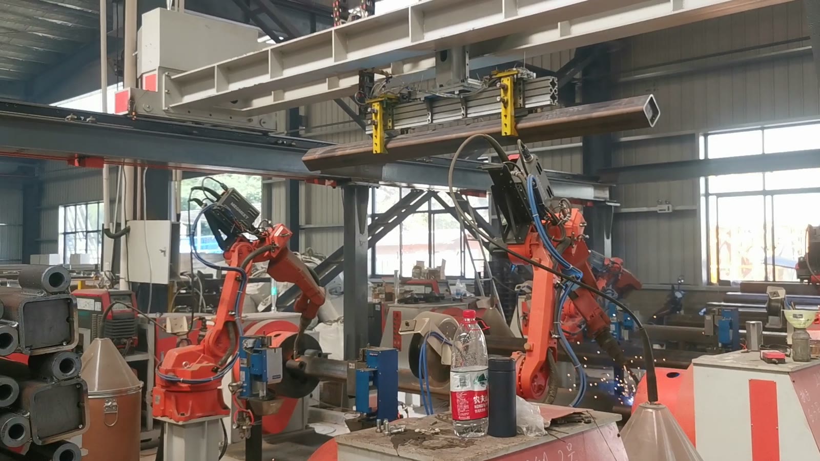Robot stations at work with members stacked alongside