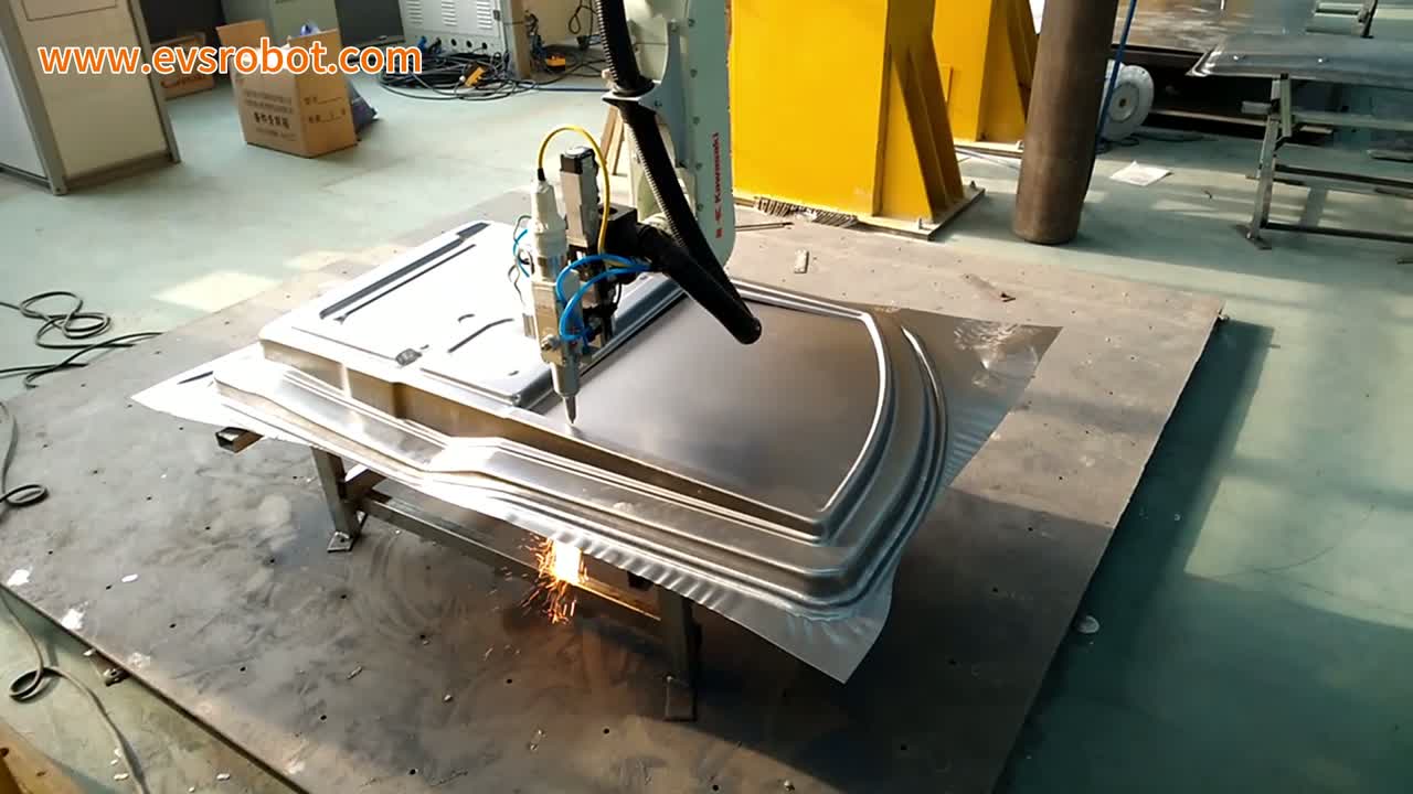 Sparks spray from the tip at the panel's lower edge onto the steel plate
