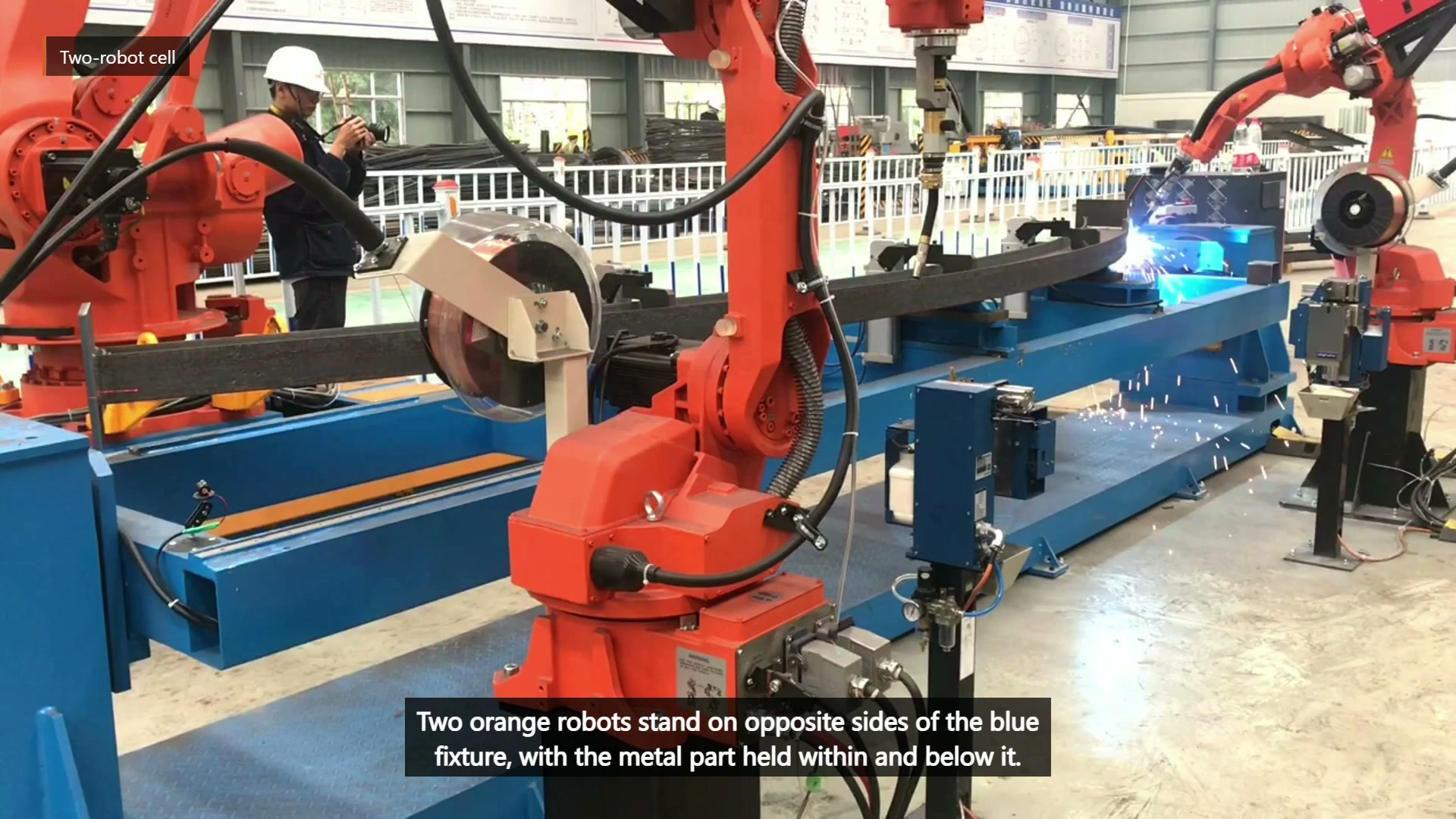 Two robots on opposite sides of the long fixture