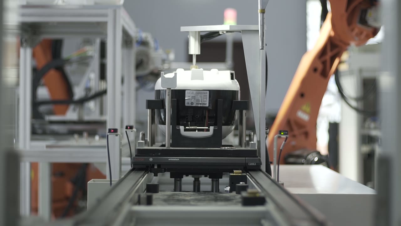 The line: appliance bodies on pallets moving between stations
