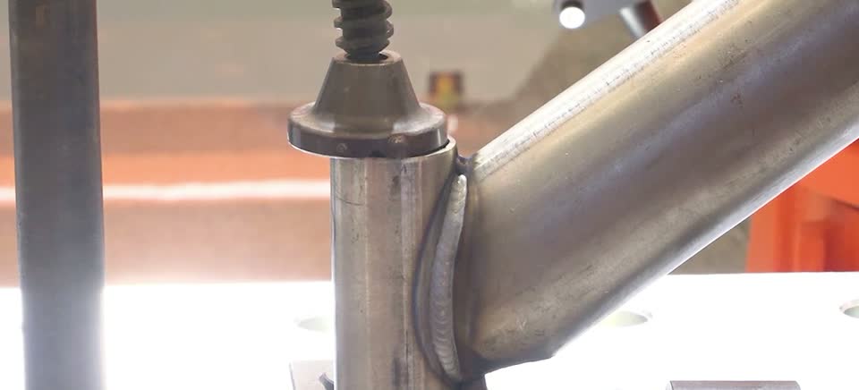 Processed close-up of a tubular intersecting joint with a fish-scale weld bead