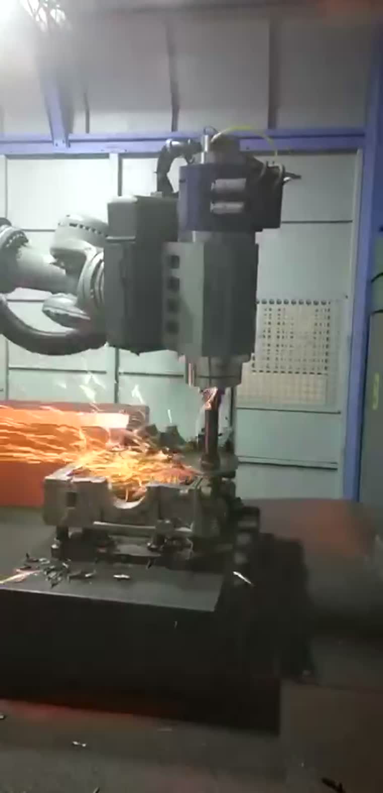 Robot-held spindle at the edge of a casting