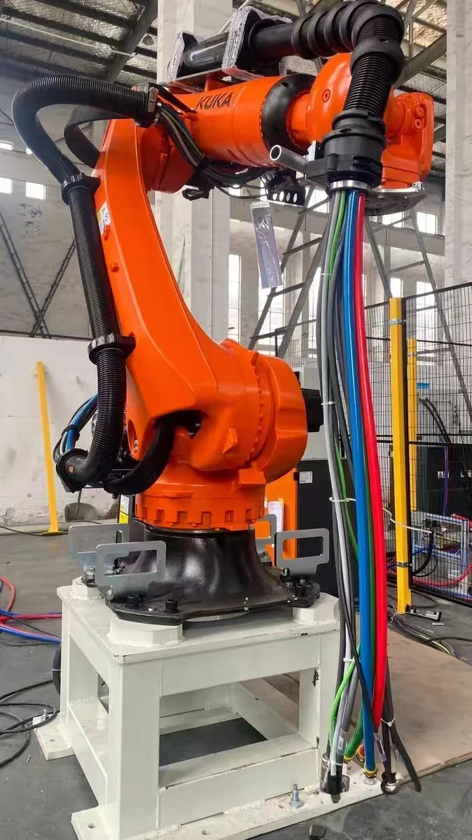 Spot-welding dress pack being installed on an industrial robot with cables and hoses fed in at the upper arm