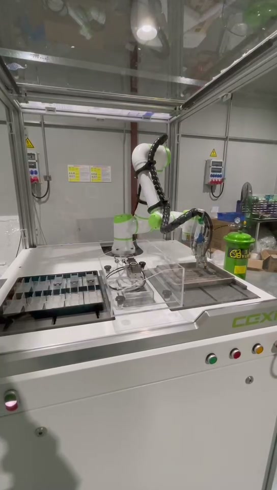 Robot reaching toward the right-hand fixture area