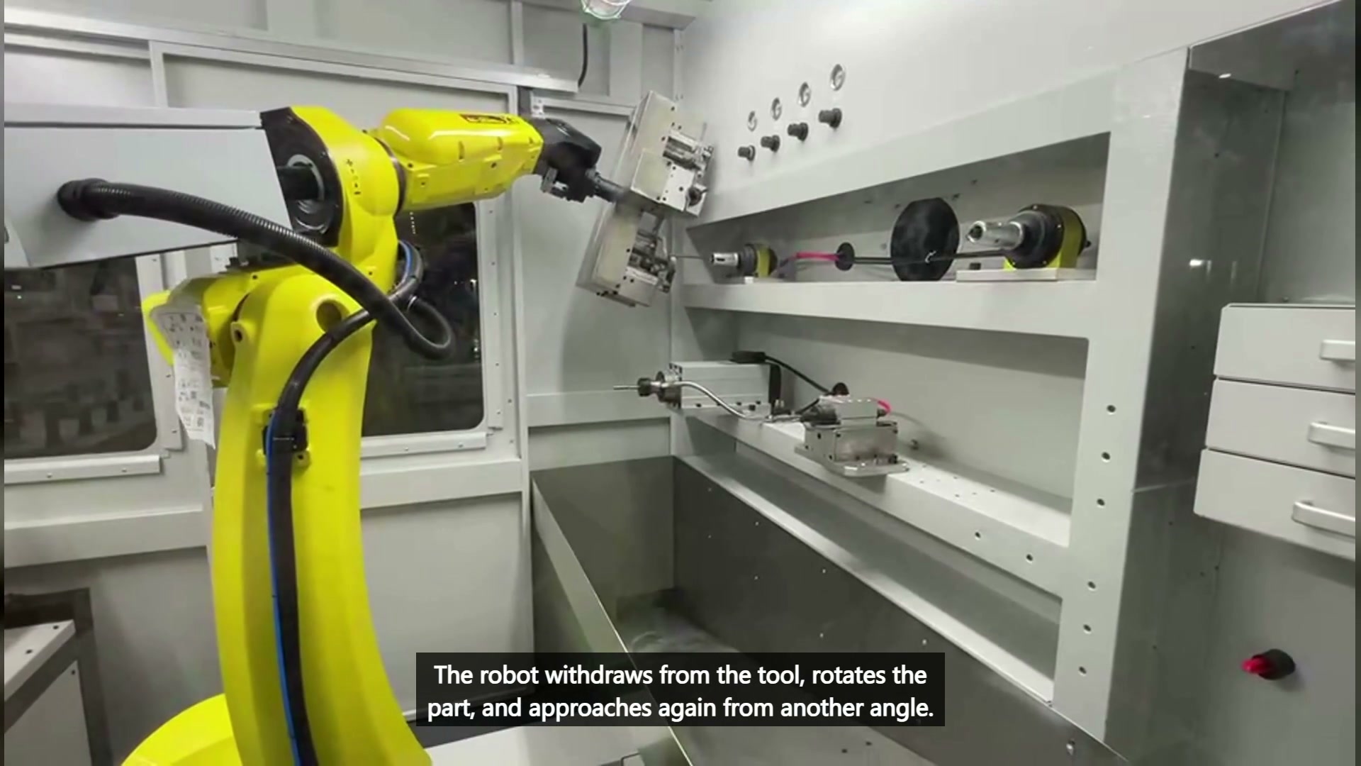 Robot wrist reorienting the fixture plate and held part away from the fixed tool