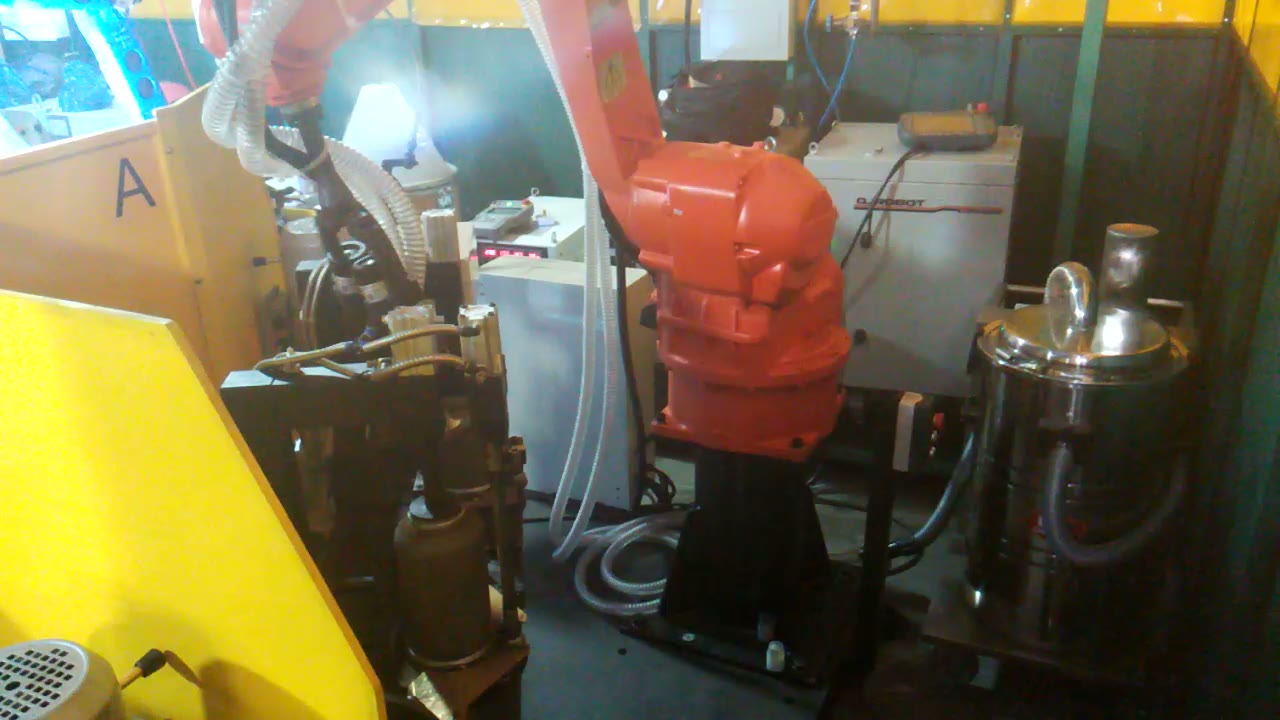 Robot tool reaching behind a yellow fixture divider