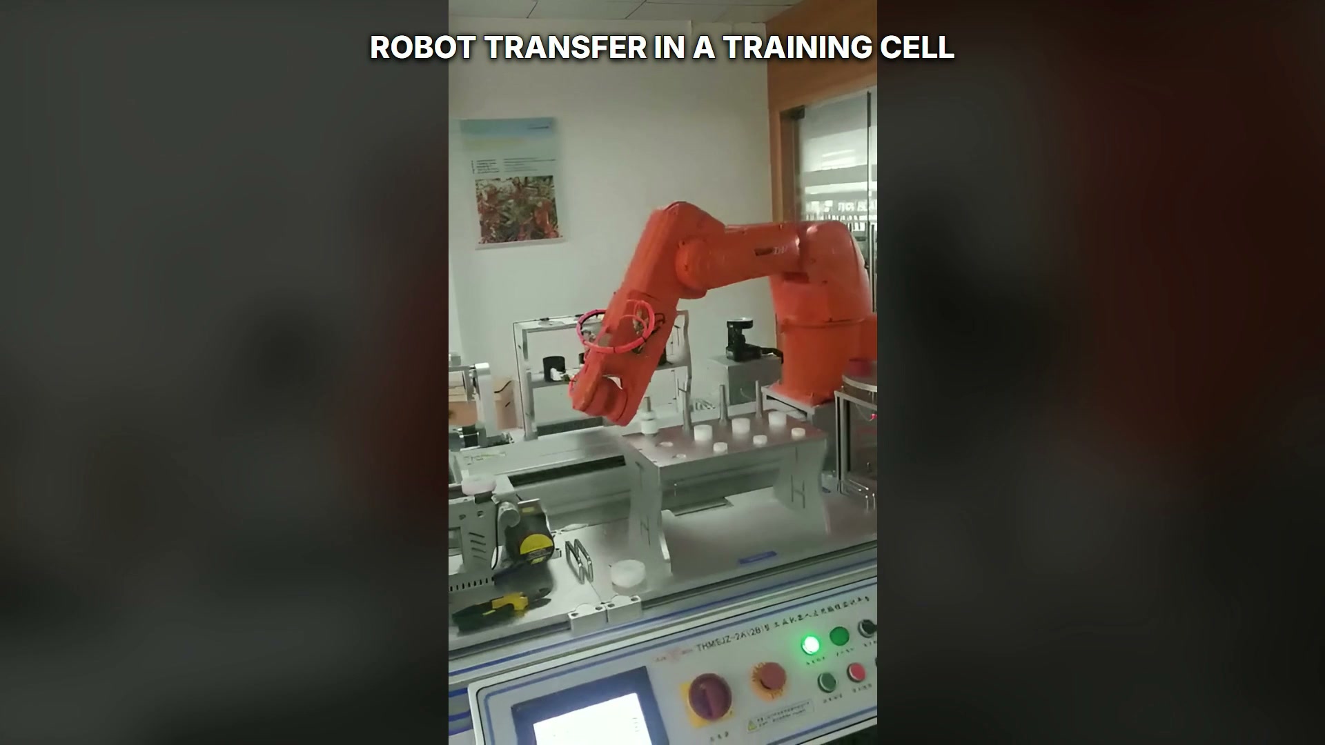 Robot positioned between adjacent fixtures with round components visible.