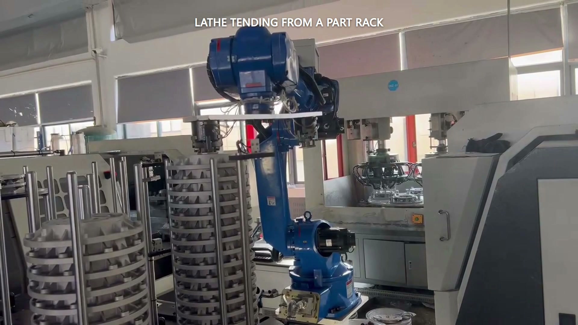 The robot handles round parts at the multi-level rack.