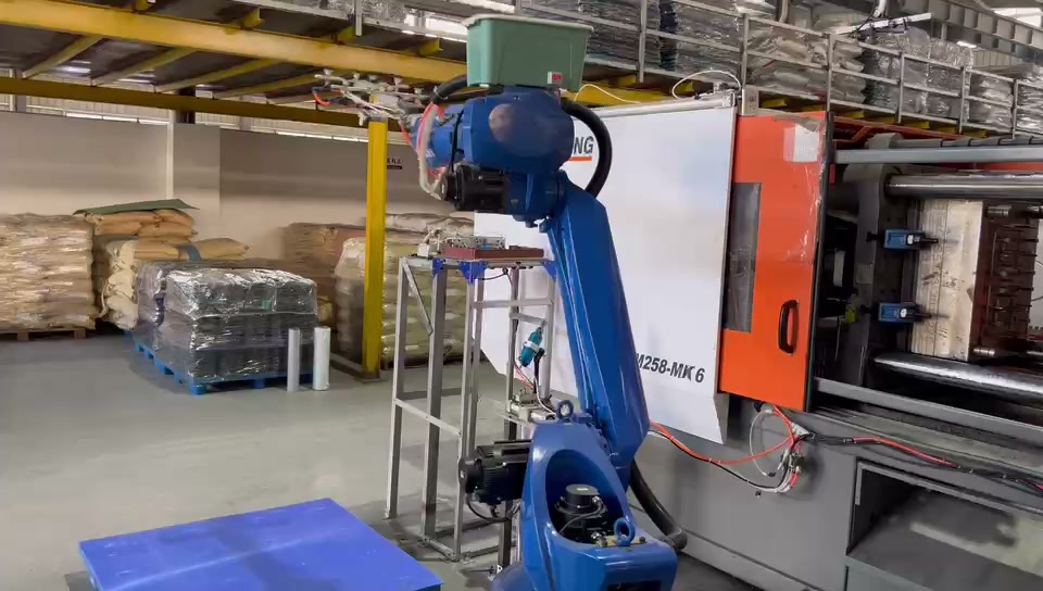 The robot descends toward the platform side of the work area.
