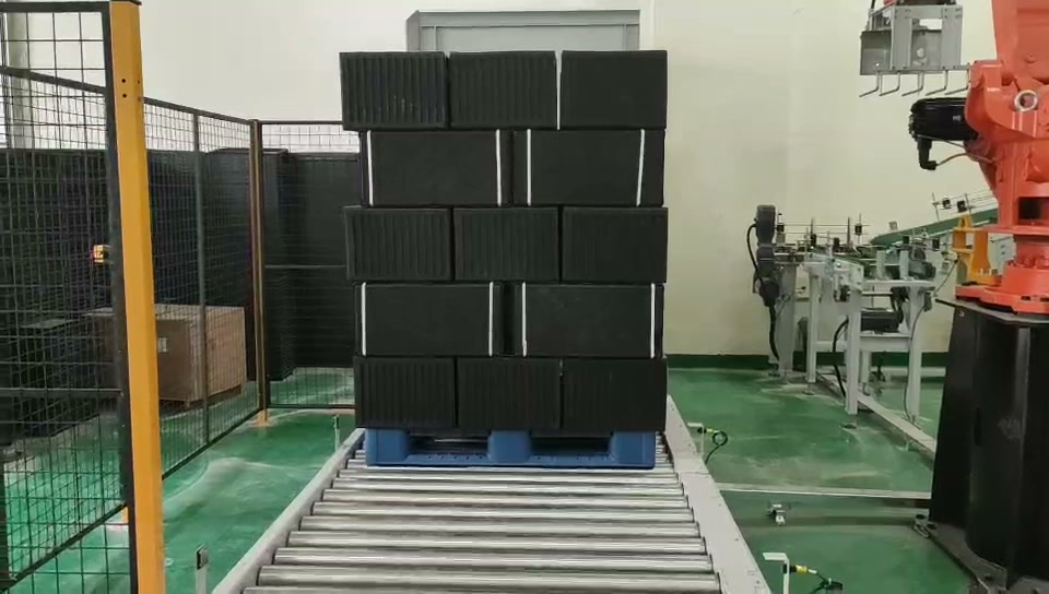 完成した黒い苗床トレイのパレットがローラーコンベアで運び出される。